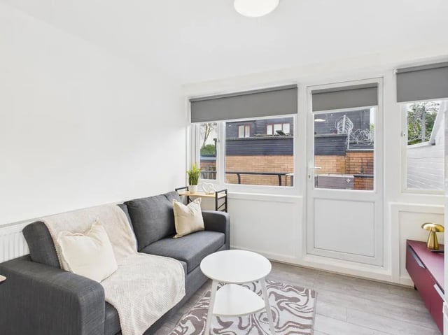 Grey sofa white rug round coffee table living room at 2 Bedroom House at Flat 8, Grove Street Studios, The Groves in Liverpool Student Accommodation