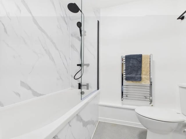 Modern bathroom with bathtub toilet and towels bathroom at 1 Bedroom House at Flat 16, Grove Street Studios, The Groves in Liverpool Student Accommodation