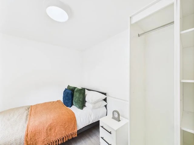 Bed pillows blanket nightstand with clock bedroom at 1 Bedroom House at Flat 22, Grove Street Studios, The Groves in Liverpool Student Accommodation