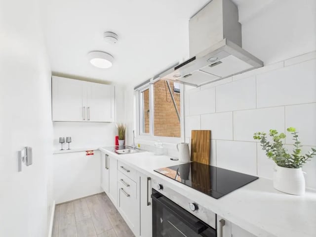 Modern white kitchen with appliances and cabinets kitchen at 1 Bedroom House at Flat 25, Grove Street Studios, The Groves in Liverpool Student Accommodation