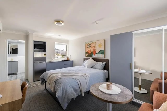Bed desk kitchenette and bathroom student studio bedroom at UKO Redfern in Sydney Student Accommodation