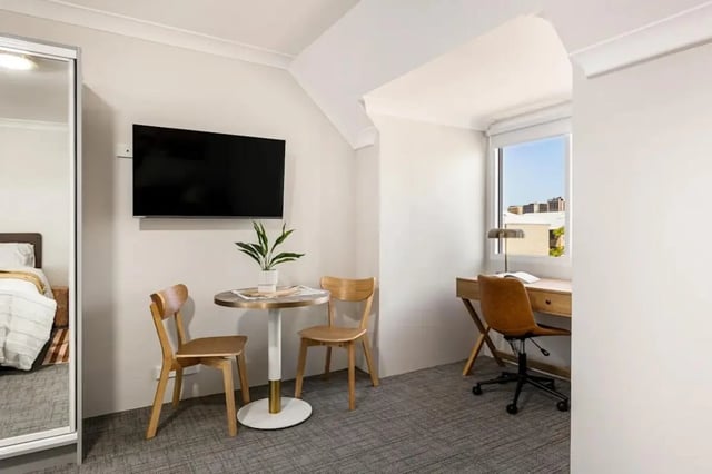 Desk chair table television plant bedroom study area at UKO Redfern in Sydney Student Accommodation