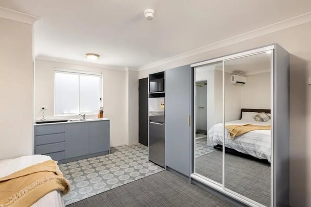Kitchen sink fridge microwave mirrored wardrobe bedroom Studio at UKO Redfern in Sydney Student Accommodation