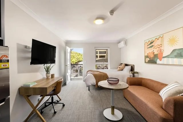 Desk bed couch table painting studio apartment at UKO Redfern in Sydney Student Accommodation