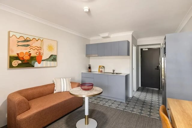 Sofa painting kitchen and doorway studio apartment at UKO Redfern in Sydney Student Accommodation