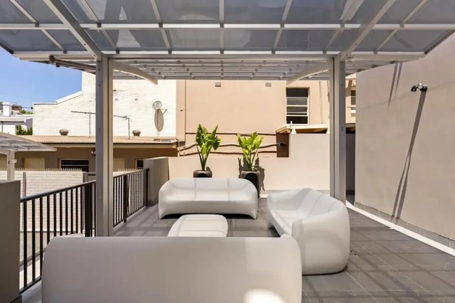 Modern white seating area with plants outdoor space at UKO Redfern in Sydney Student Accommodation