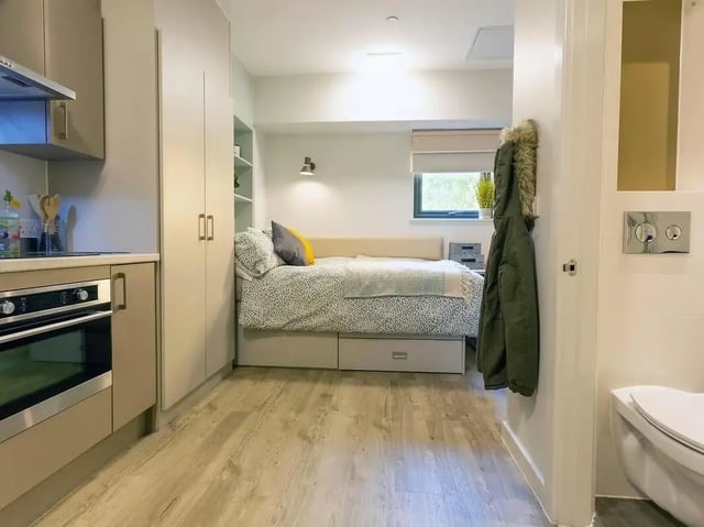 Kitchen bed built-in wardrobe and toilet studio apartment at SEREN in Swansea Student Accommodation