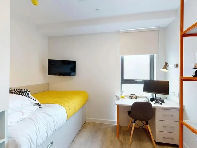 Bed desk television and shelving bedroom at SEREN in Swansea Student Accommodation