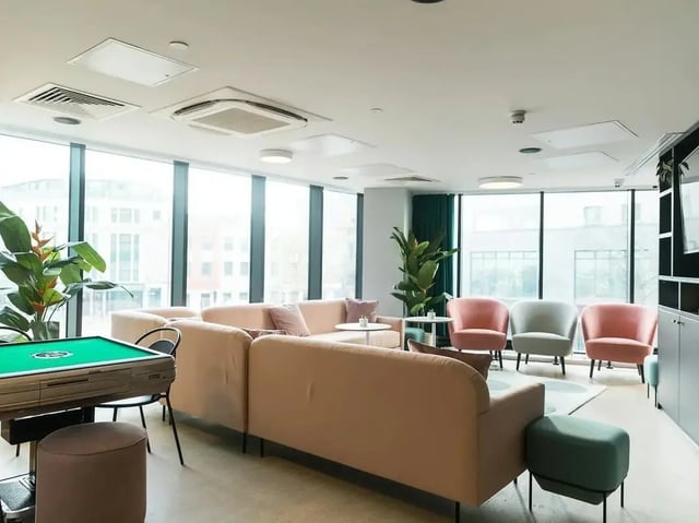 Mahjong table couches chairs plants living room at SEREN in Swansea Student Accommodation