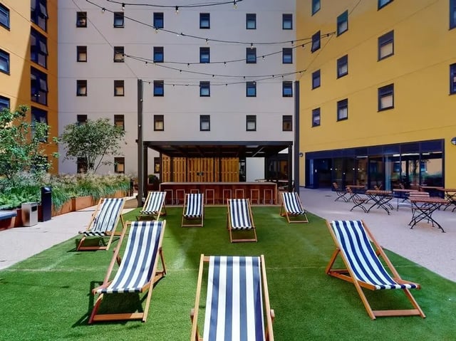 Deck chairs and outdoor bar area exterior at SEREN in Swansea Student Accommodation