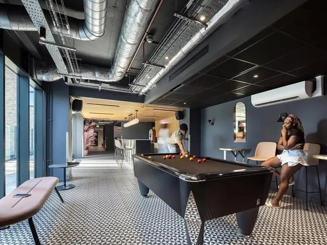 Pool table and seating area communal space at SEREN in Swansea Student Accommodation