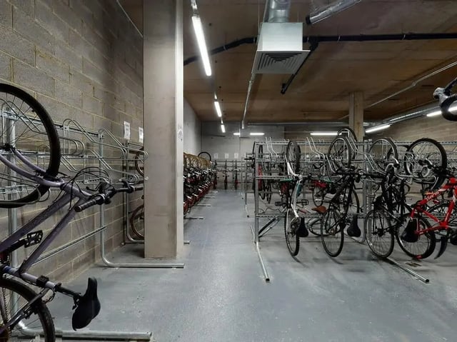 Bicycles parked in tiered racks common area storage at SEREN in Swansea Student Accommodation