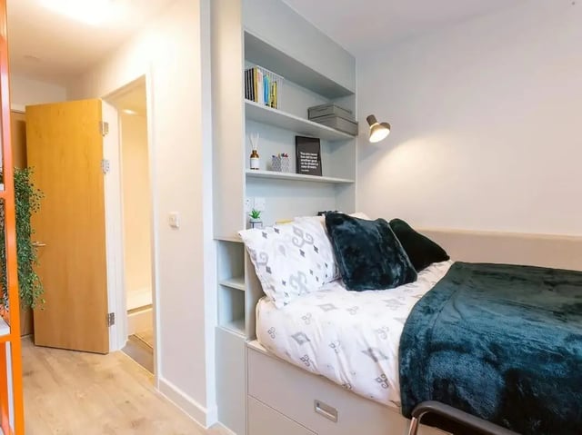 Bed with storage shelves and lamp bedroom at SEREN in Swansea Student Accommodation