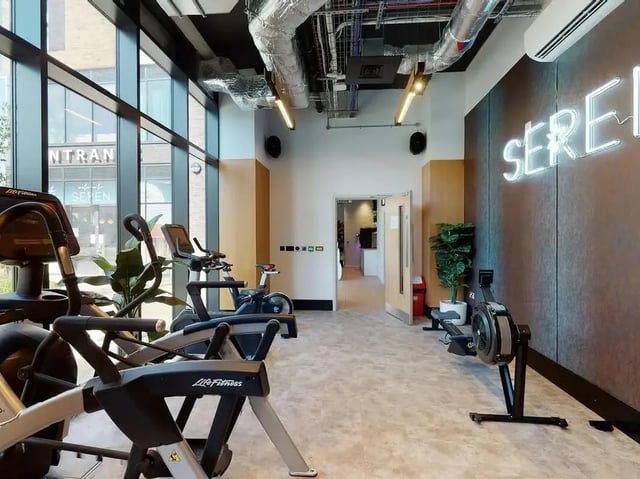 Gym equipment includes treadmills stationary bikes and rowing machine gym. at SEREN in Swansea Student Accommodation