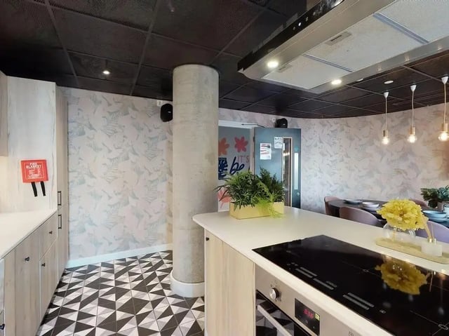 Modern kitchen with island stovetop and cabinets Kitchen at SEREN in Swansea Student Accommodation