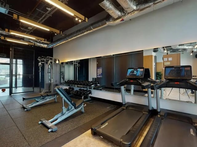 Treadmills weight benches and dumbbells gym area at SEREN in Swansea Student Accommodation
