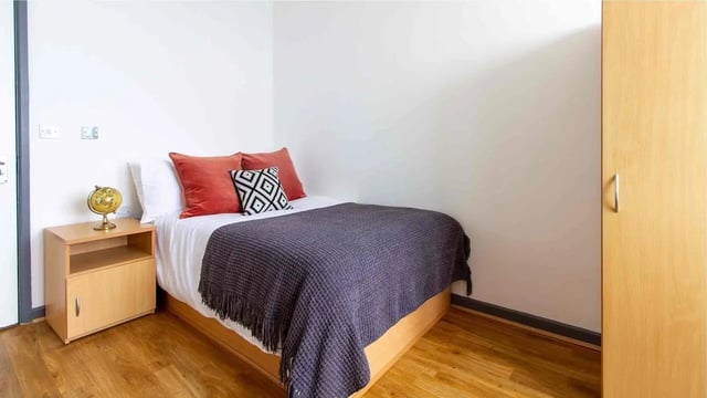 Bed nightstand globe and wardrobe bedroom at Alexandra Hall in Aberystwyth Student Accommodation