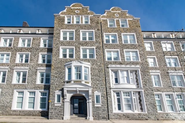 Stone building facade with many white windows exterior at Alexandra Hall in Aberystwyth Student Accommodation