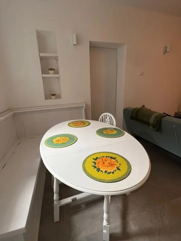 Oval dining table with placemats built-in seating living area at Entire Apartment In Tapigliano Near Lago Maggiore in Tapigliano Student Accommodation
