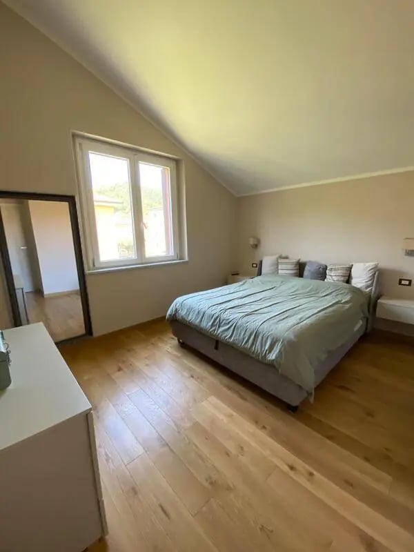 Bed dresser mirror large window bedroom at Welcoming double ensuite bedroom near the Vezzano Ligure train station in La Spezia Student Accommodation