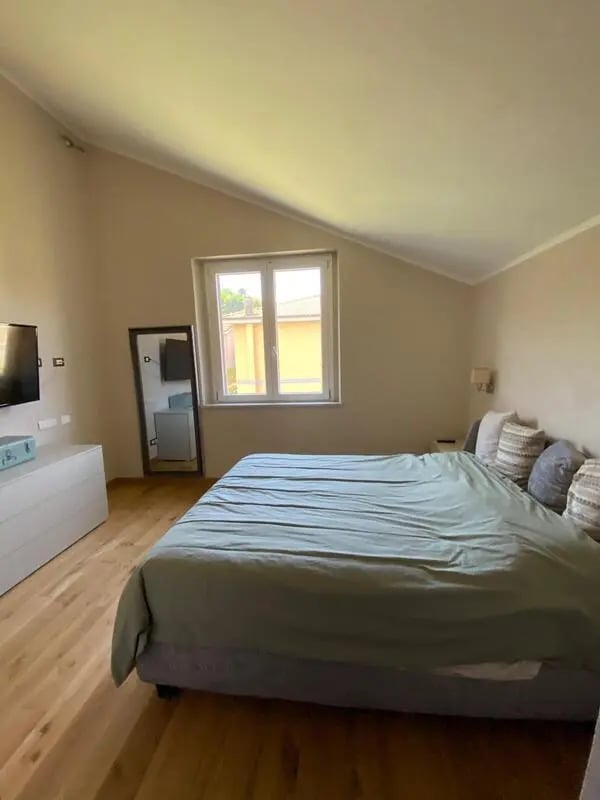 Bed dresser mirror window bedroom at Welcoming double ensuite bedroom near the Vezzano Ligure train station in La Spezia Student Accommodation