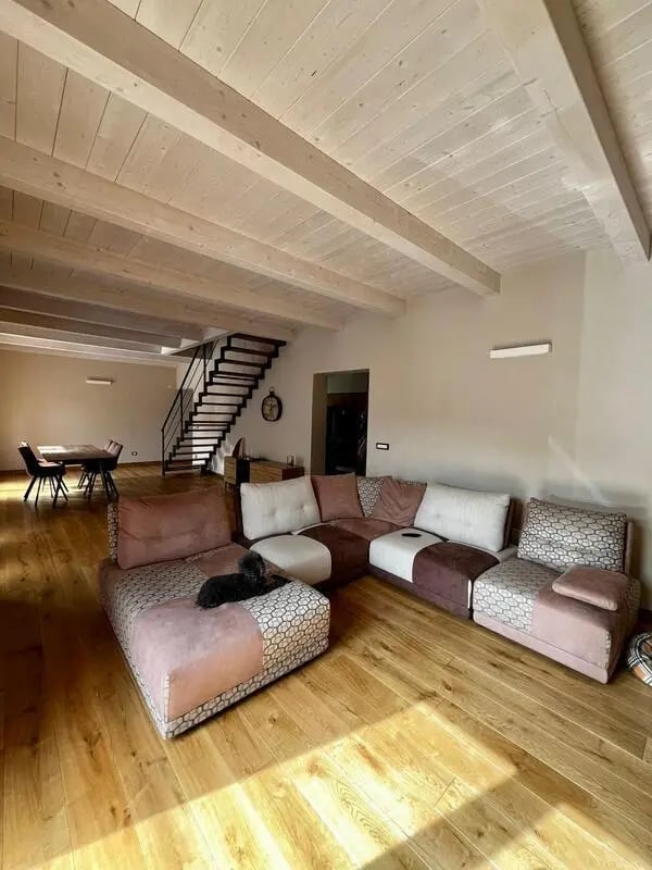 Sofa with modern sectional and wood floor Living room at Welcoming double ensuite bedroom near the Vezzano Ligure train station in La Spezia Student Accommodation