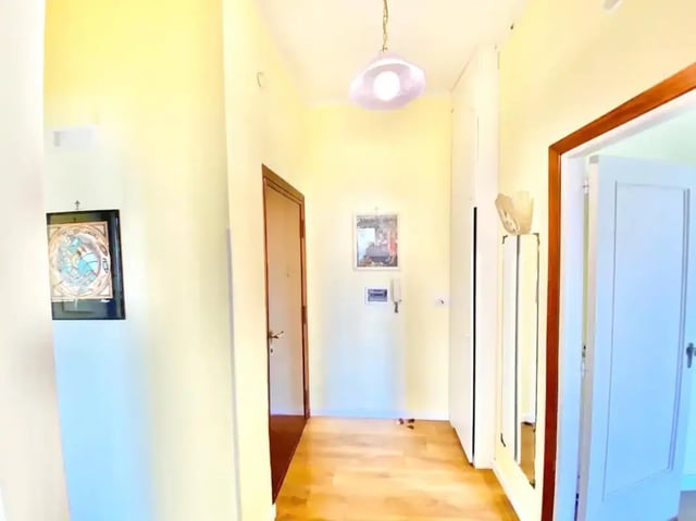 Hallway with pictures and doors hallway at Appartamento soleggiato con ampia terrazza, giardino e parcheggio in Sant'Agnello Student Accommodation