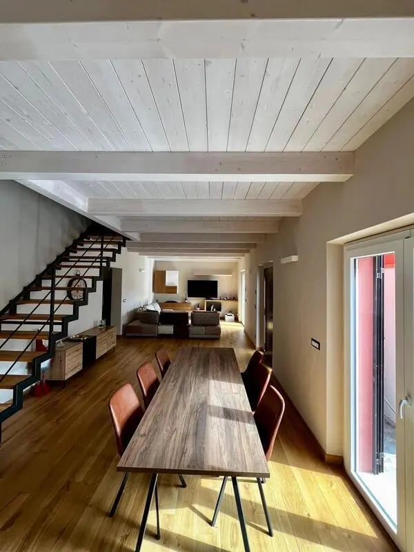 Dining table, chairs, sofa, television, stairs, living room at Welcoming double ensuite bedroom near the Vezzano Ligure train station in La Spezia Student Accommodation