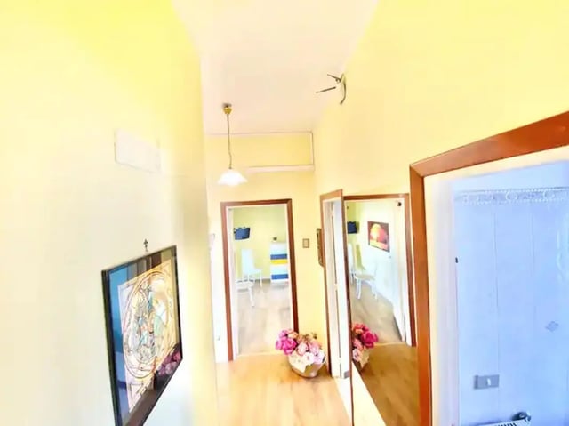 Hallway with artwork doors and flowers hallway at Appartamento soleggiato con ampia terrazza, giardino e parcheggio in Sant'Agnello Student Accommodation
