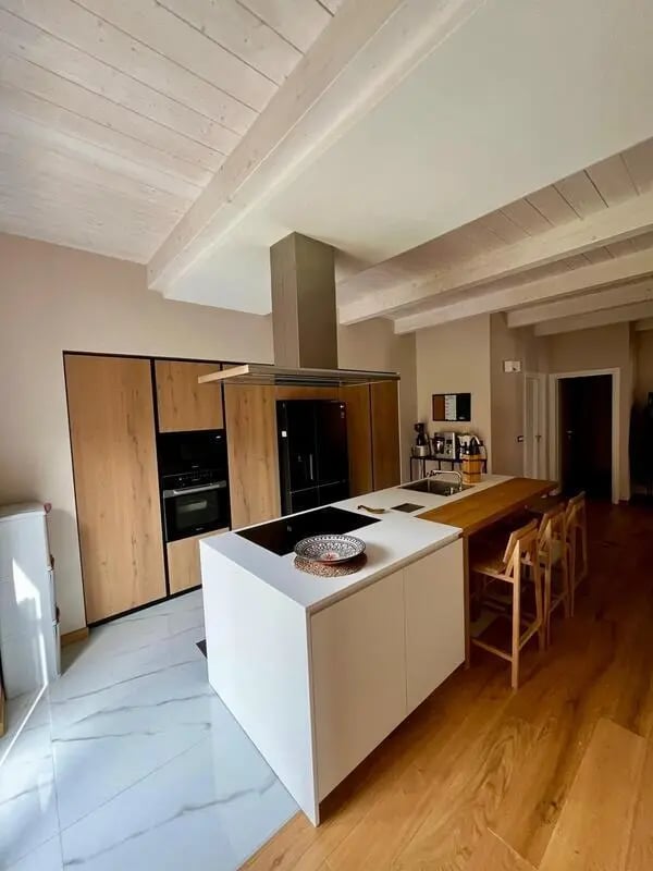 Modern white island and wooden cabinets kitchen at Welcoming double ensuite bedroom near the Vezzano Ligure train station in La Spezia Student Accommodation