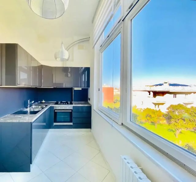 Modern grey kitchen with oven and sink kitchen at Appartamento di due stanze in Sant'Agnello Student Accommodation
