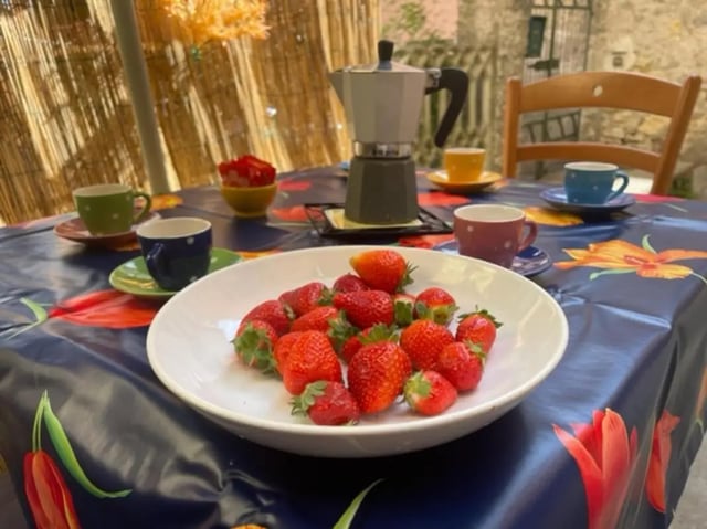 Strawberries coffee cups and moka pot table setting at 2-bedroom house, with outdoor area in La Spezia Student Accommodation