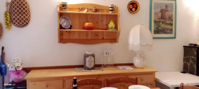 Wooden dresser with items and wall shelf dining area at 2-bedroom house, with outdoor area in La Spezia Student Accommodation