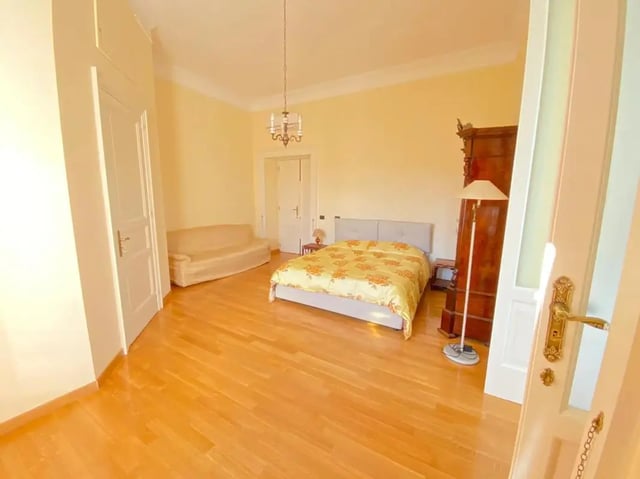 Bed, sofa, wooden wardrobe, lamp, bedroom at Appartamento di due stanze in Sant'Agnello Student Accommodation
