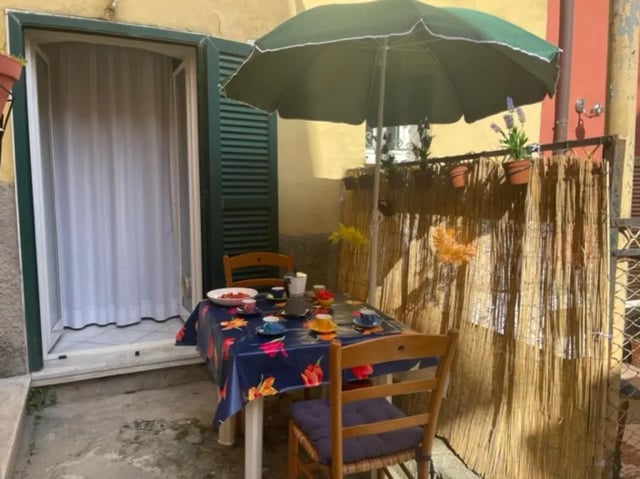 Patio table with cups and chairs patio area at 2-bedroom house, with outdoor area in La Spezia Student Accommodation