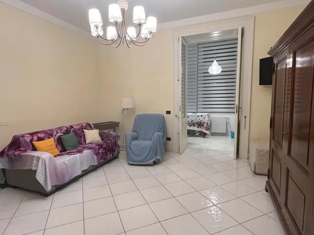Sofa armchair cabinet and hallway living room at Appartamento di due stanze in Sant'Agnello Student Accommodation