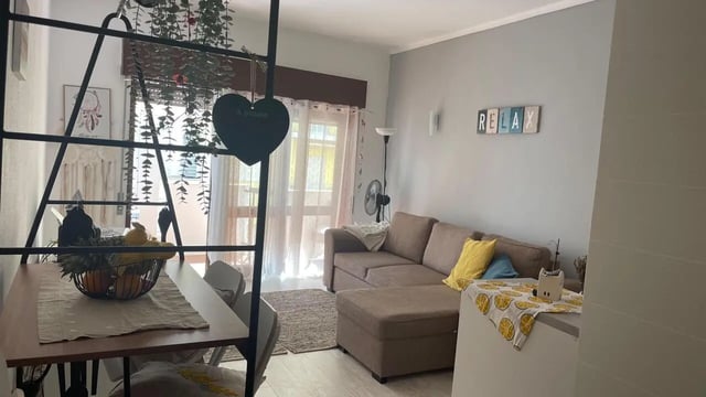 Brown sectional sofa with pillows and fruit basket living room at 1-bedroom flat in Armação de Pêra with balcony all electric no Gas in Silves Student Accommodation