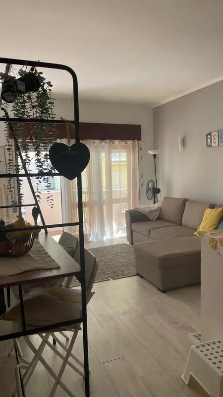 Sofa table plants and chairs living room at 1-bedroom flat in Armação de Pêra with balcony all electric no Gas in Silves Student Accommodation