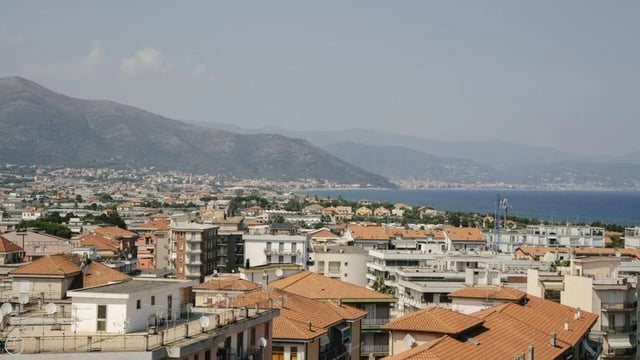 Cityscape with mountains and sea exterior at Welcoming 2-bedroom apartment near the Albenga train station in Albenga Student Accommodation