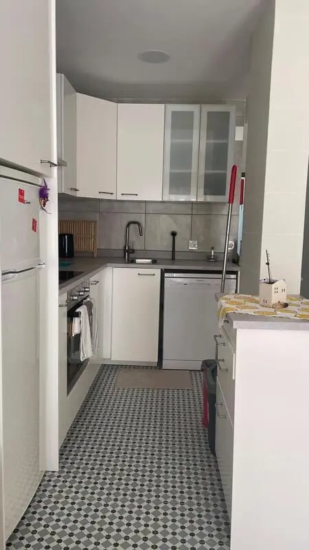Refrigerator dishwasher sink cabinets tiled floor kitchen at 1-bedroom flat in Armação de Pêra with balcony all electric no Gas in Silves Student Accommodation