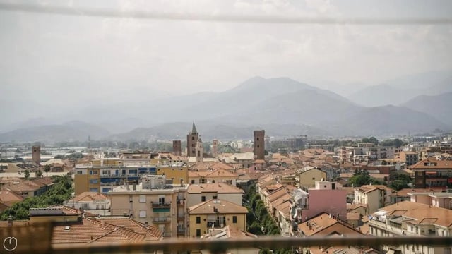 Cityscape with buildings and mountains exterior at Welcoming 2-bedroom apartment near the Albenga train station in Albenga Student Accommodation