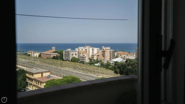 City buildings and ocean view from balcony exterior at Welcoming 2-bedroom apartment near the Albenga train station in Albenga Student Accommodation