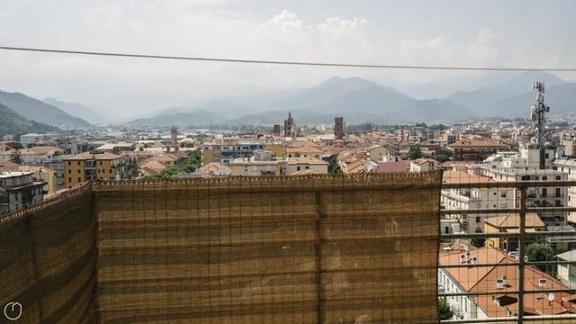 Buildings with tan bamboo screen and mountain view exterior at Welcoming 2-bedroom apartment near the Albenga train station in Albenga Student Accommodation