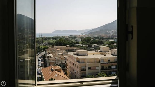 Apartment buildings view and sea exterior at Welcoming 2-bedroom apartment near the Albenga train station in Albenga Student Accommodation