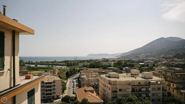Apartment buildings near coast and mountains exterior at Welcoming 2-bedroom apartment near the Albenga train station in Albenga Student Accommodation