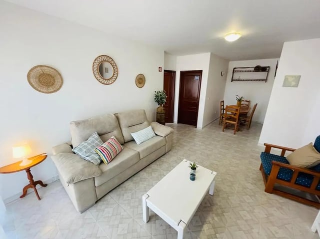 Sofa coffee table chairs and dining table living room at Sunny flat very close to the beach in Faro Student Accommodation