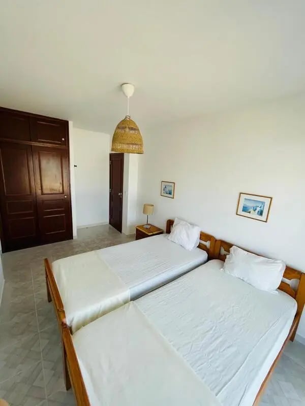 Two beds wardrobe artwork bedroom at Sunny flat very close to the beach in Faro Student Accommodation