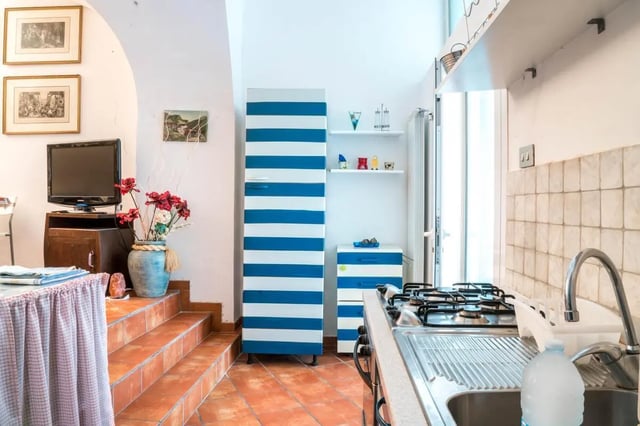 Striped fridge gas stove sink kitchen at Cosy double-bedroom apartment in Albenga (SV) in Albenga Student Accommodation