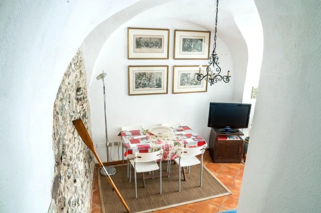 Dining table with chairs and television living room at Cosy double-bedroom apartment in Albenga (SV) in Albenga Student Accommodation
