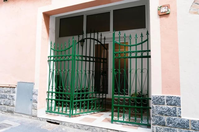Green gate and door exterior. at Cosy double-bedroom apartment in Albenga (SV) in Albenga Student Accommodation
